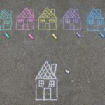 assorted-color house illustration on gray concrete surface