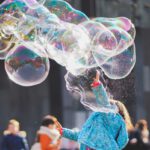 woman blowing bubbles